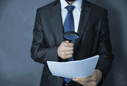 a man looking over papers with a magnifying glass