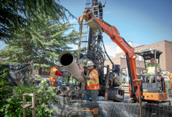 a worker moving a pipe