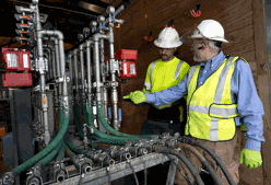 A photo of site workers inspecting an injection system
